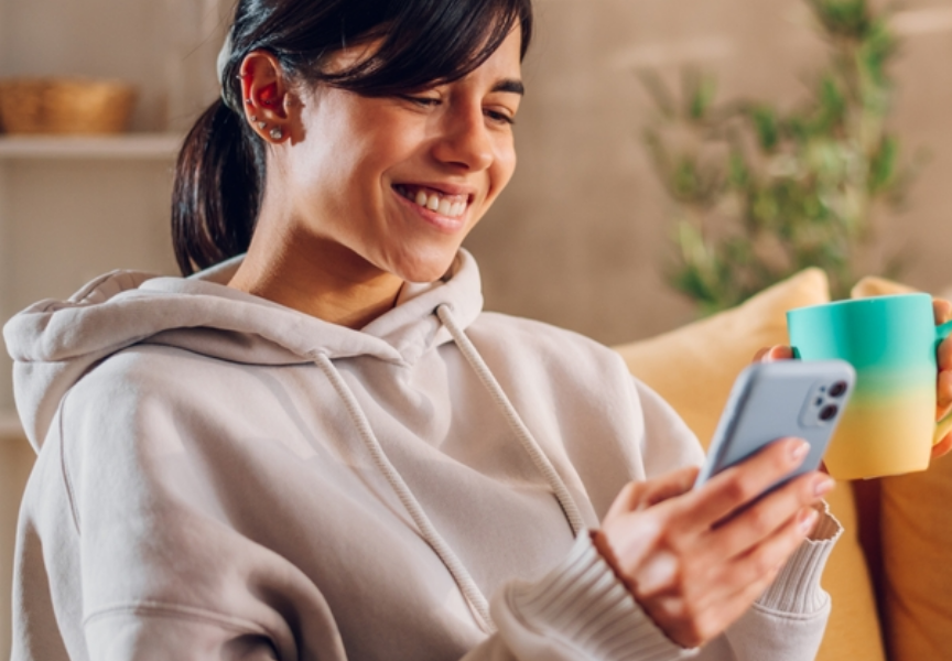 Happy female looking at phone