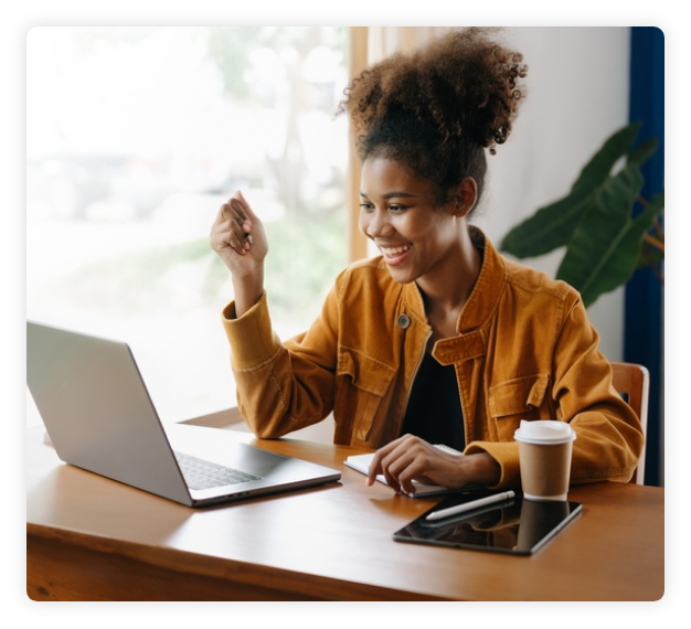 Happy female looking at her laptop