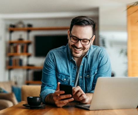 Happy man looking at his phone