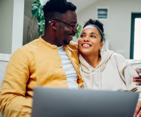 Happy female looking at her laptop